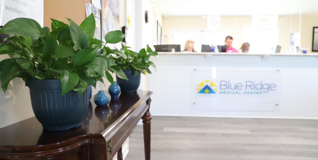 Front Desk at Blue Ridge Medical Center with a plant on a table